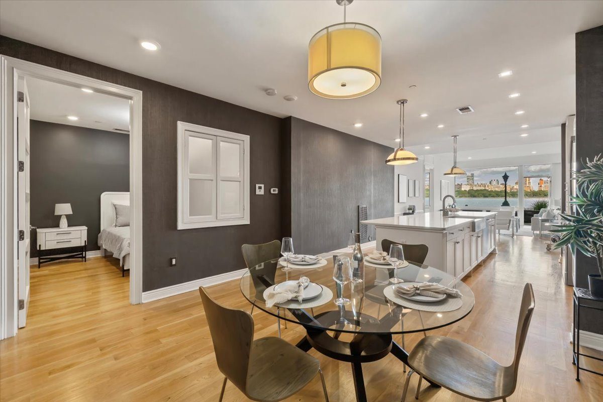 Dining table set for guests in a bright condo with river views
