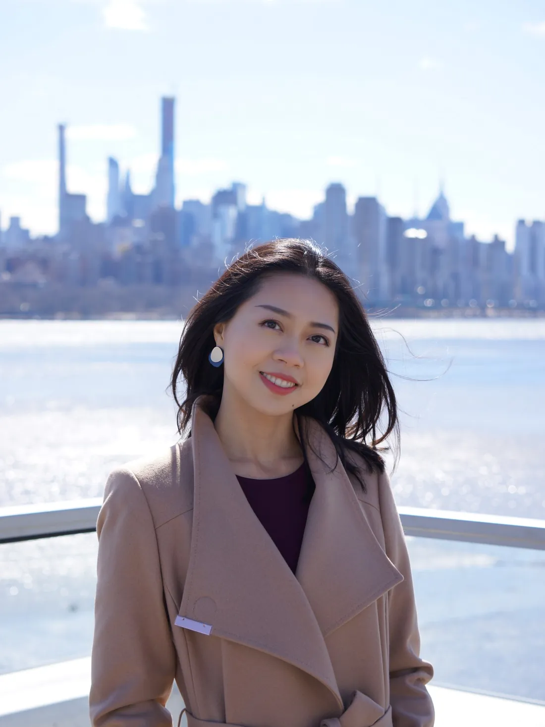 Chuling “Sharleen” Yuan on the Hudson waterfront, with the Manhattan skyline behind her